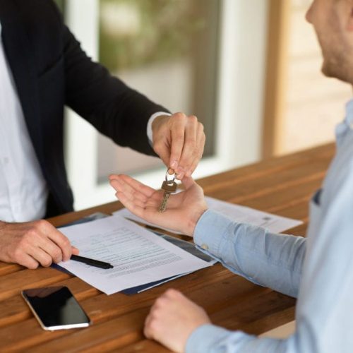 closeup-view-of-real-estate-agent-giving-house-key-2025-03-18-18-15-52-utc-w1080-h1920 An agent handing over keys to a home