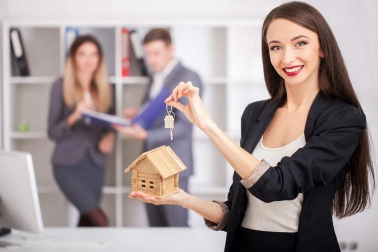 A happy new real estate agent with clients